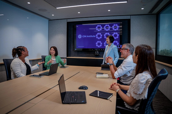 A group of colleagues sat in a meeting room having a discussion