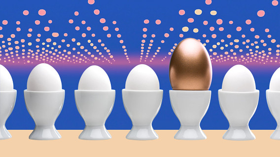 A row of white eggs in white egg cups against a blue background. One egg is shiny gold, standing out in the center. The background features soft, glowing dots, creating a festive feel. The image symbolizes uniqueness among the ordinary.