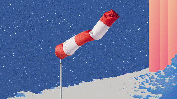 A red and white wind sock mounted on a pole stands against a deep blue starry sky. The foreground features a snowy landscape with icy textures, while a gradient of pink light and abstract shapes appear on the right side, adding a surreal and atmospheric touch to the scene.