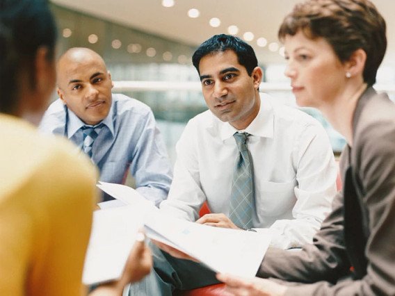 Three people at table in a meeting