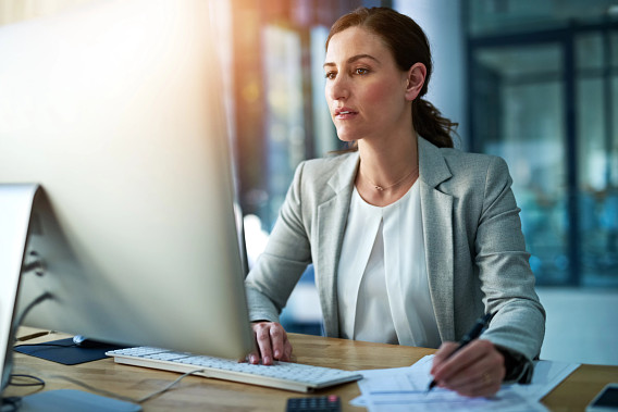 woman with serious expression in front of computer